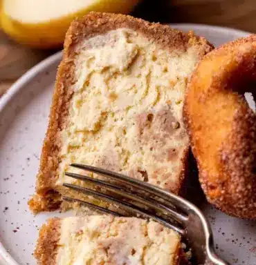 Delicious slice of Apple Cider Cheesecake topped with caramel drizzle