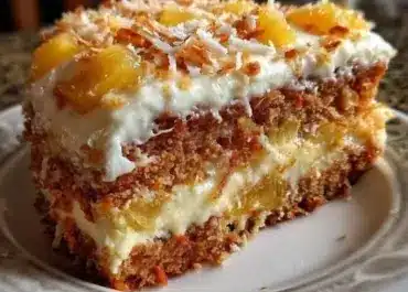 Delicious slice of Hawaiian Carrot Pineapple Cake topped with cream cheese frosting
