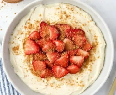 High protein cheesecake yogurt bowl topped with berries and nuts.
