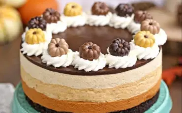 Delicious slice of Pumpkin Chocolate Mousse Cake topped with whipped cream